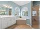 Bathroom with a garden tub, large vanity, and separate shower at 6026 Landings Blvd, Lady Lake, FL 32159