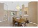 Bright dining room with a charming chandelier and an oval dining table at 6026 Landings Blvd, Lady Lake, FL 32159