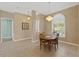 Bright dining room with a charming chandelier and an oval dining table at 6026 Landings Blvd, Lady Lake, FL 32159