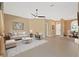 Spacious living room featuring neutral tones, plush seating, and a ceiling fan at 6026 Landings Blvd, Lady Lake, FL 32159