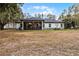 Home exterior showcasing a screened porch and backyard at 6832 Maryland Ave, Groveland, FL 34736