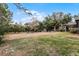 Large backyard with mature trees and grassy areas at 6832 Maryland Ave, Groveland, FL 34736