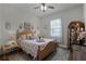 Charming bedroom with a queen-size bed, decorative accents, and ceiling fan at 6832 Maryland Ave, Groveland, FL 34736