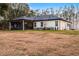 White house exterior with screened porch and landscaping at 6832 Maryland Ave, Groveland, FL 34736