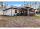 White house exterior with screened porch and large backyard at 6832 Maryland Ave, Groveland, FL 34736