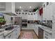 Modern kitchen with white cabinets, granite countertops, and stainless steel appliances at 6832 Maryland Ave, Groveland, FL 34736