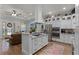 Bright kitchen with stainless steel appliances, white cabinets, and granite countertops at 6832 Maryland Ave, Groveland, FL 34736