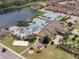 Community pool, tennis courts, playground, and clubhouse with surrounding homes at 8955 Coco Palm Rd, Kissimmee, FL 34747