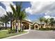 Elegant community clubhouse entrance with palm trees at 8955 Coco Palm Rd, Kissimmee, FL 34747