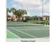 Community tennis court with surrounding tropical landscaping at 8955 Coco Palm Rd, Kissimmee, FL 34747