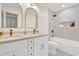 Elegant bathroom with double vanity, a bathtub, and marble-look tiles at 1238 Cheetah Trl, Winter Springs, FL 32708