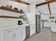 White kitchen with wine fridge and floating shelves at 1238 Cheetah Trl, Winter Springs, FL 32708