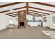 Open living room with exposed wooden beams, a brick fireplace, and new flooring at 1238 Cheetah Trl, Winter Springs, FL 32708