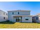 Two-story house with gray siding and patio at 1304 Silo Dr, St Cloud, FL 34771