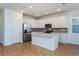 Modern kitchen with white cabinets, stainless steel appliances, and an island at 1304 Silo Dr, St Cloud, FL 34771