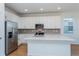 Modern kitchen with white cabinets, stainless steel appliances, and an island at 1304 Silo Dr, St Cloud, FL 34771
