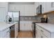 Modern kitchen with white cabinets, stainless steel appliances, and an island at 1304 Silo Dr, St Cloud, FL 34771