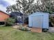 Spacious backyard with shed and screened-in pool area at 1415 Park Ave, Tavares, FL 32778