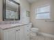 Clean bathroom with granite countertop, white cabinets and a shower/tub combo at 1415 Park Ave, Tavares, FL 32778
