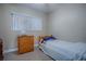 Cozy bedroom with wood dresser and a comfortable twin-sized bed at 1415 Park Ave, Tavares, FL 32778