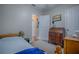 Charming bedroom with a view of the hallway, a dresser and a twin bed at 1415 Park Ave, Tavares, FL 32778