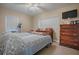 Spacious bedroom with king-size bed, dresser, and a ceiling fan at 1415 Park Ave, Tavares, FL 32778