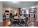 Dining area with dark wood table and chairs, hardwood floors and view of kitchen at 1415 Park Ave, Tavares, FL 32778