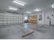 Large garage with overhead door and workshop area at 1415 Park Ave, Tavares, FL 32778