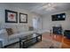 Spacious living room featuring hardwood floors, comfortable sofa, and access to patio at 1415 Park Ave, Tavares, FL 32778
