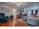 Living room with hardwood floors, comfortable seating and a view of the kitchen at 1415 Park Ave, Tavares, FL 32778