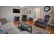 Living room with hardwood floors, comfy seating, and a fireplace at 1415 Park Ave, Tavares, FL 32778