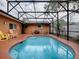 Inviting pool and patio area with screened enclosure at 1415 Park Ave, Tavares, FL 32778
