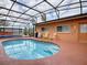 Inviting kidney-shaped pool with a covered patio at 1415 Park Ave, Tavares, FL 32778