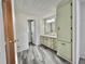 Bright bathroom with cabinet and drawers for storage, a sink, and grey vinyl flooring at 149 Royal Palm Dr, Leesburg, FL 34748