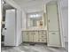 Bright bathroom features a vanity with cabinets, drawers, and a large wall cabinet, offering storage at 149 Royal Palm Dr, Leesburg, FL 34748