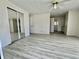 Spacious bedroom with mirrored closet, ceiling fan, updated flooring, and access to ensuite bathroom at 149 Royal Palm Dr, Leesburg, FL 34748