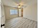 This bedroom features vinyl flooring, a ceiling fan, and a closet at 149 Royal Palm Dr, Leesburg, FL 34748