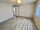 Bedroom with closet, ceiling fan, and grey vinyl flooring at 149 Royal Palm Dr, Leesburg, FL 34748
