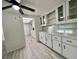 Bright dining area with a ceiling fan, modern flooring, and built-in cabinets at 149 Royal Palm Dr, Leesburg, FL 34748