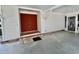 Covered entry featuring a vibrant red double door with brick trim and modern door hardware at 149 Royal Palm Dr, Leesburg, FL 34748