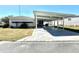 Charming single-story home featuring a spacious carport and well-maintained front lawn at 149 Royal Palm Dr, Leesburg, FL 34748
