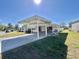 Inviting single-story home with a large carport, covered porch, and manicured lawn at 149 Royal Palm Dr, Leesburg, FL 34748