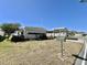 Charming single-story home showcasing a well-maintained front lawn and covered parking at 149 Royal Palm Dr, Leesburg, FL 34748