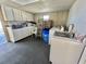 Efficient laundry room with ample storage, utility sink, washer, and dryer at 149 Royal Palm Dr, Leesburg, FL 34748