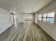 Bright living room featuring modern flooring, neutral walls, and natural light from multiple windows at 149 Royal Palm Dr, Leesburg, FL 34748