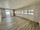 Bright living room featuring modern gray flooring, white walls, and lots of natural light at 149 Royal Palm Dr, Leesburg, FL 34748