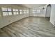 Inviting living room featuring modern floors and lots of natural light from ample windows at 149 Royal Palm Dr, Leesburg, FL 34748