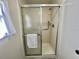 Bright shower with glass enclosure, grab bar, and white subway tile surround at 149 Royal Palm Dr, Leesburg, FL 34748