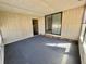 Large sunroom with lots of windows and a sliding glass door for outdoor access at 149 Royal Palm Dr, Leesburg, FL 34748