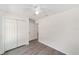 Bedroom with wood-look floors, closet and an attached bathroom featuring modern finishes at 15323 Sw 25Th Pl, Ocala, FL 34482